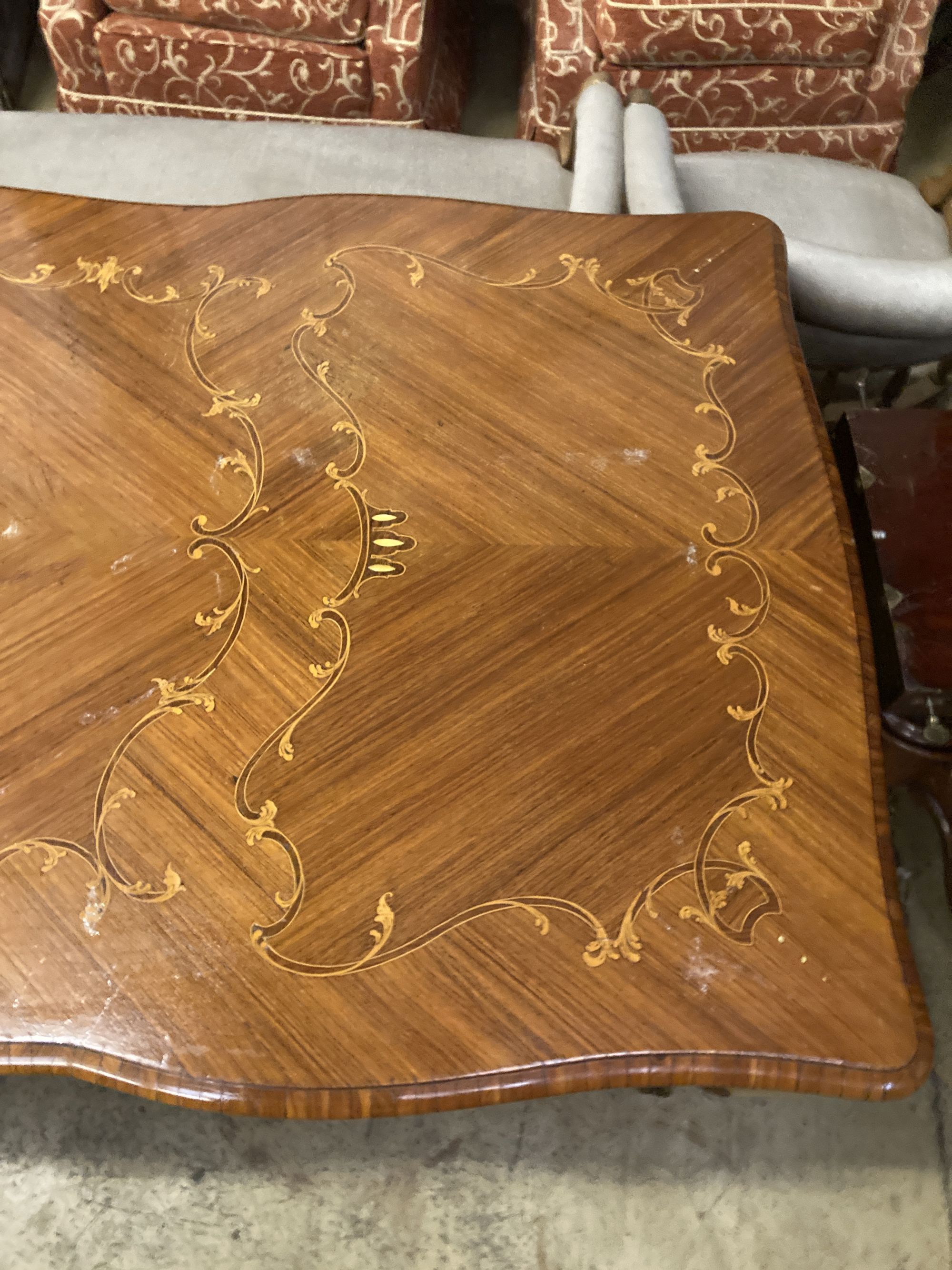 A Louis XVI design marquetry inlaid kingwood serpentine centre table W.196cm. D.90cm. H 79cm.